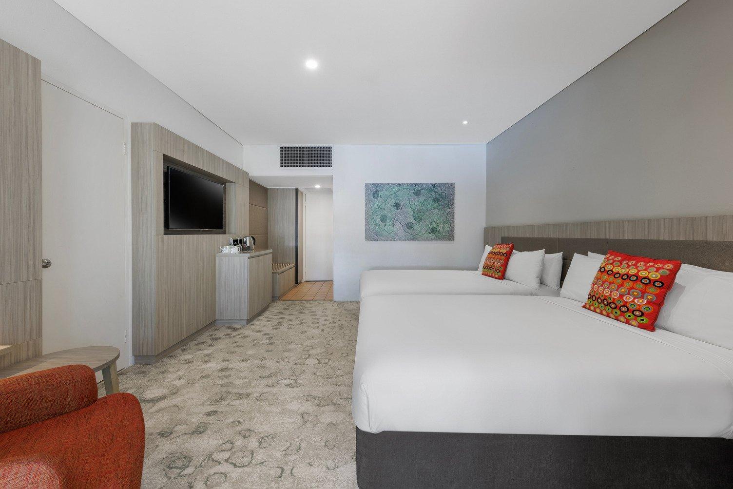 2 Double beds with Tv mounted to wall and kitchenette