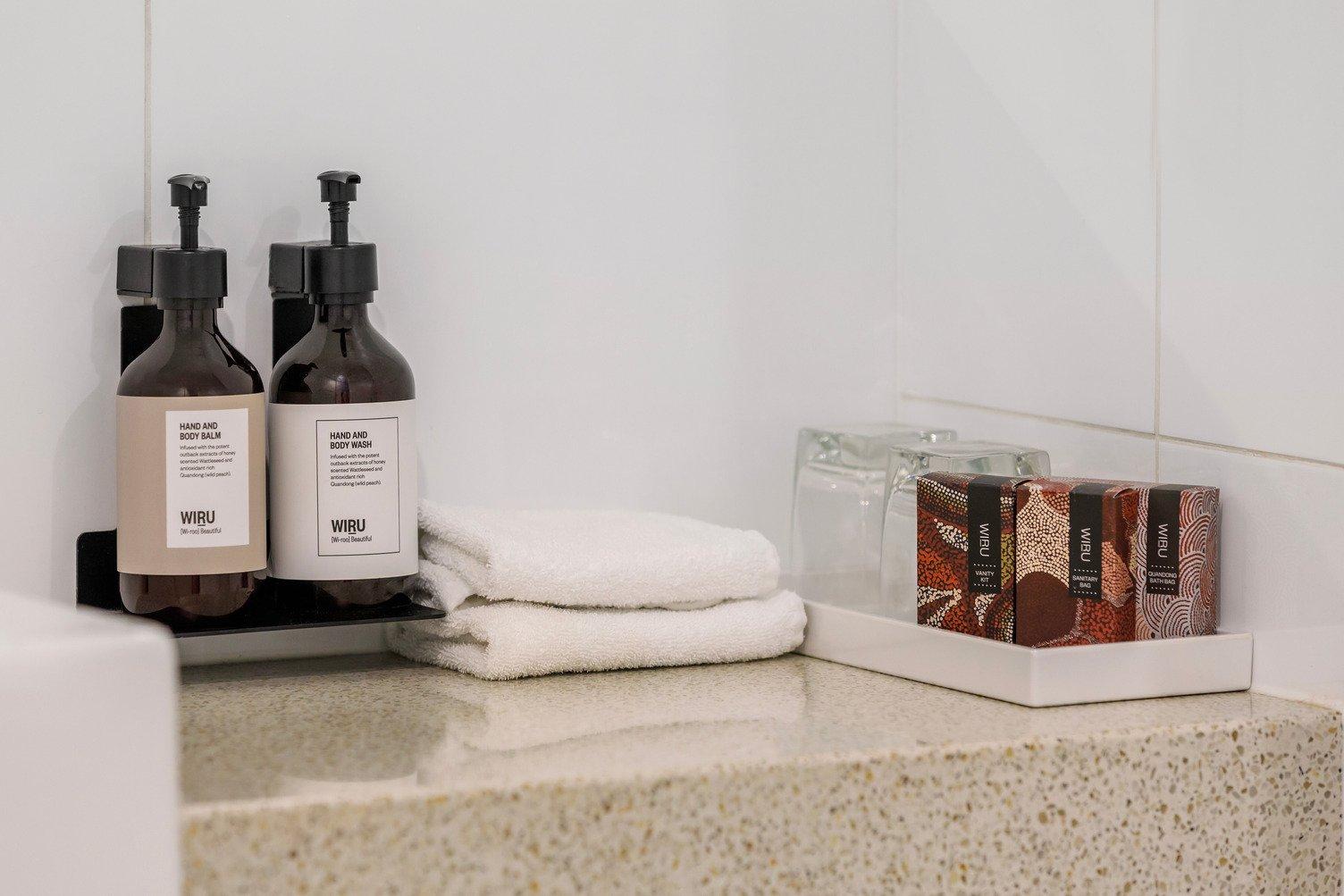 Complimentary shower and bath products on a benchtop in the bathroom
