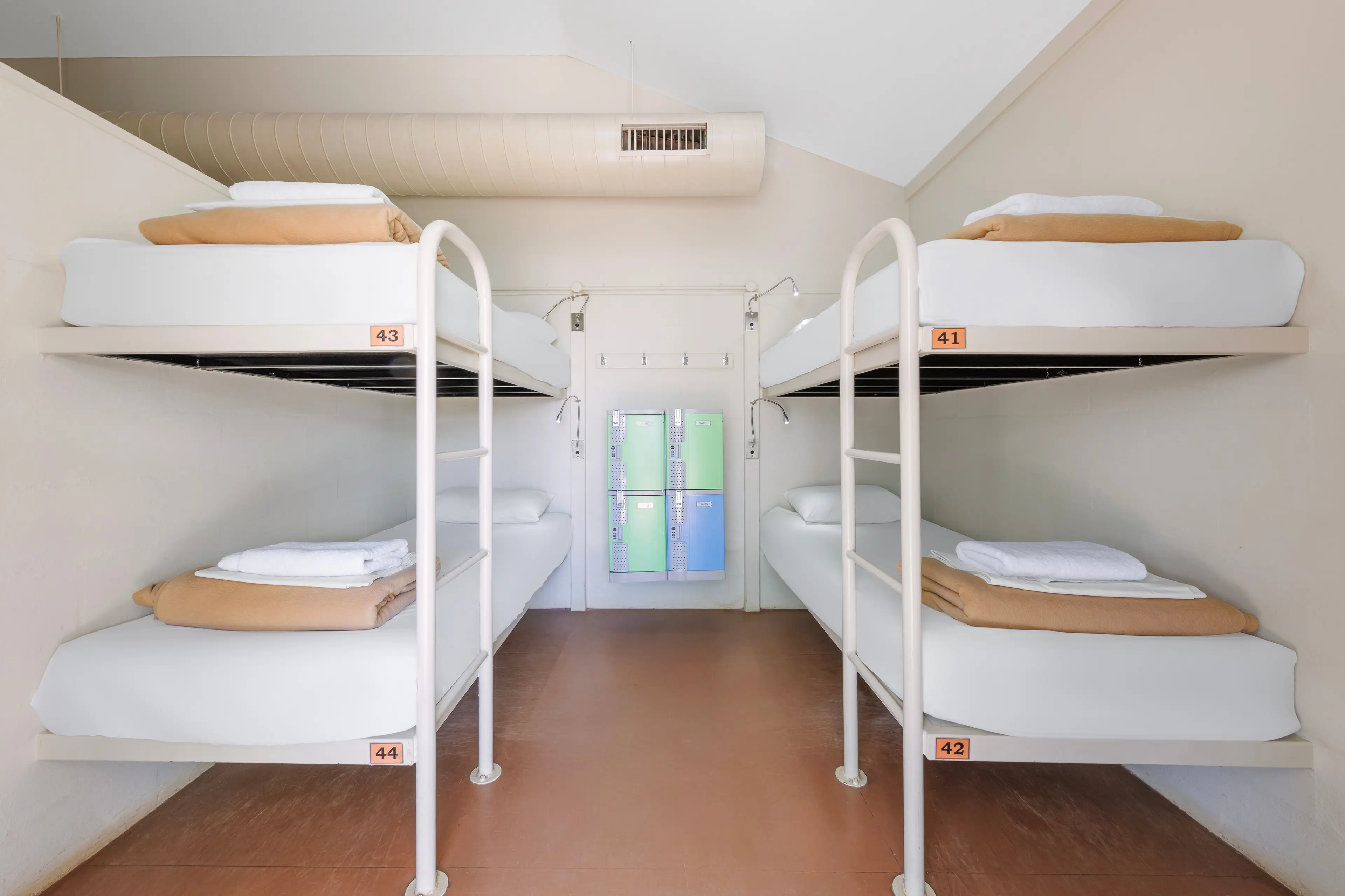 2 beds that sit within a 20 bed dormitory