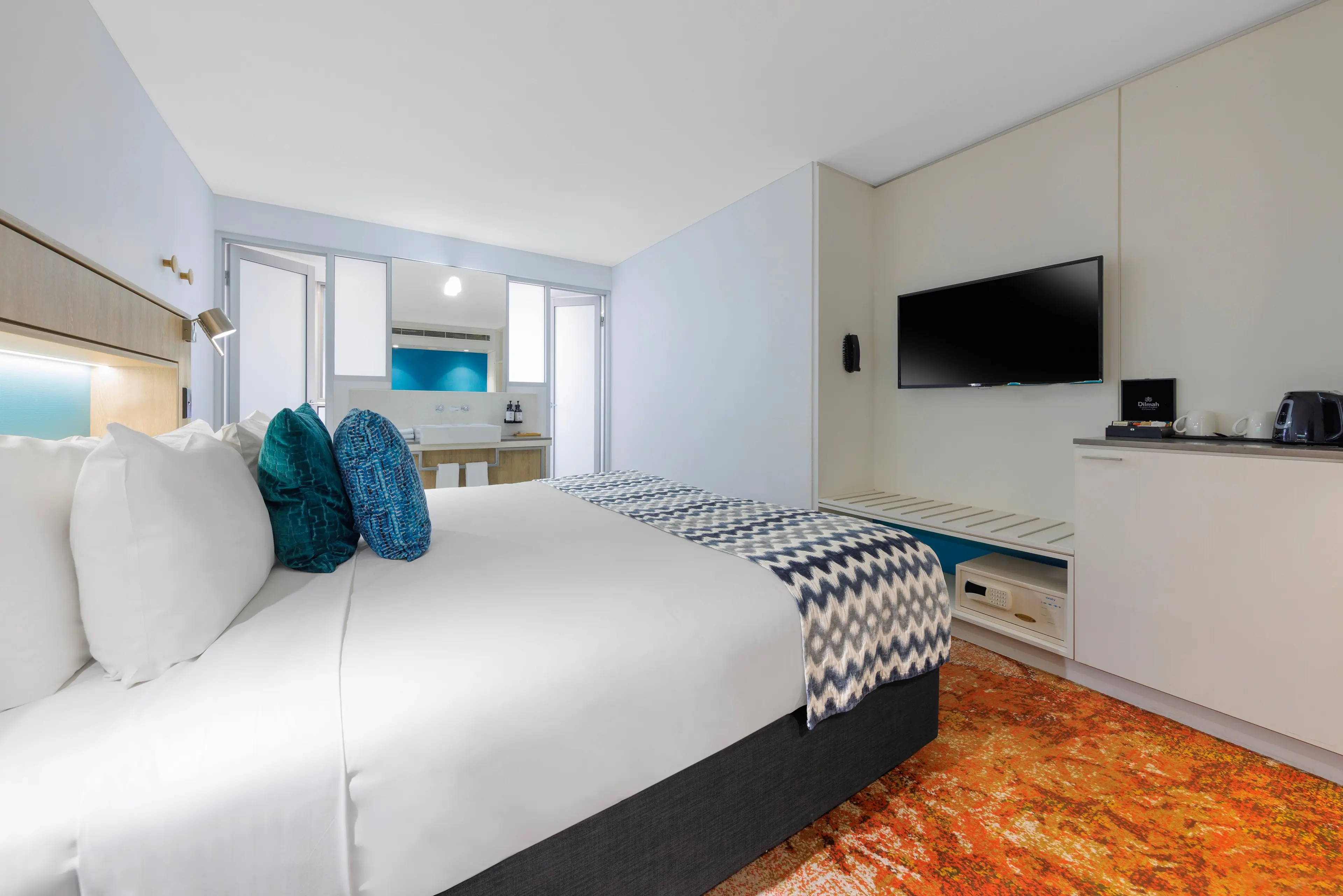 View from entrance with King bed, TV on wall, bathroom