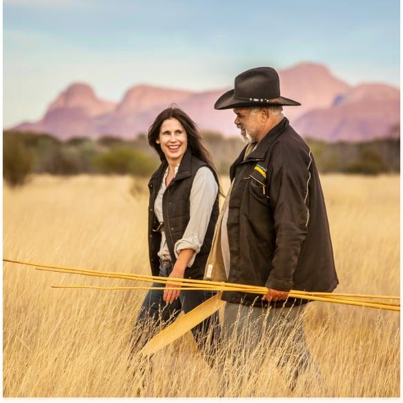 Two people walk together through the outback. Men and women walking together in the Australian ourback