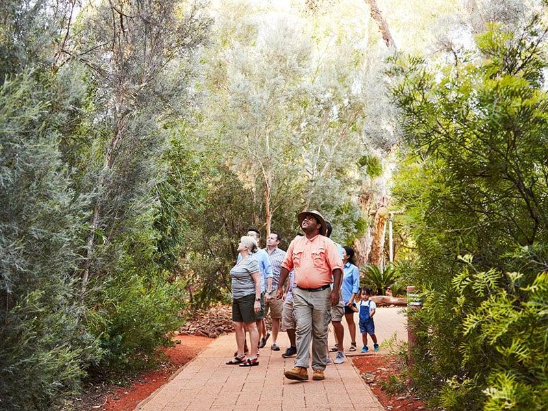 Group taking guided tour of gardens at Ayers Rock Resort