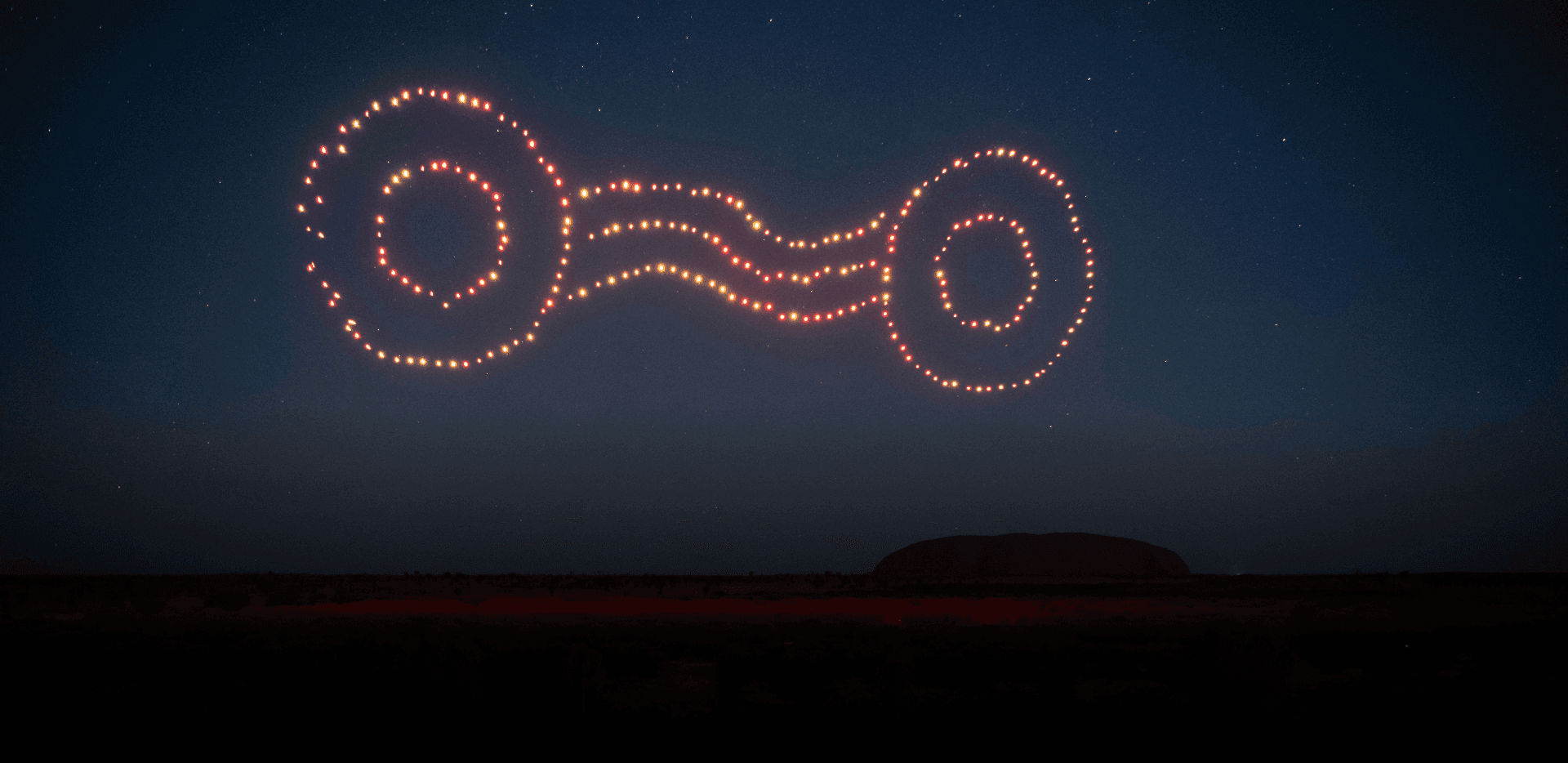 illuminated drones making shape