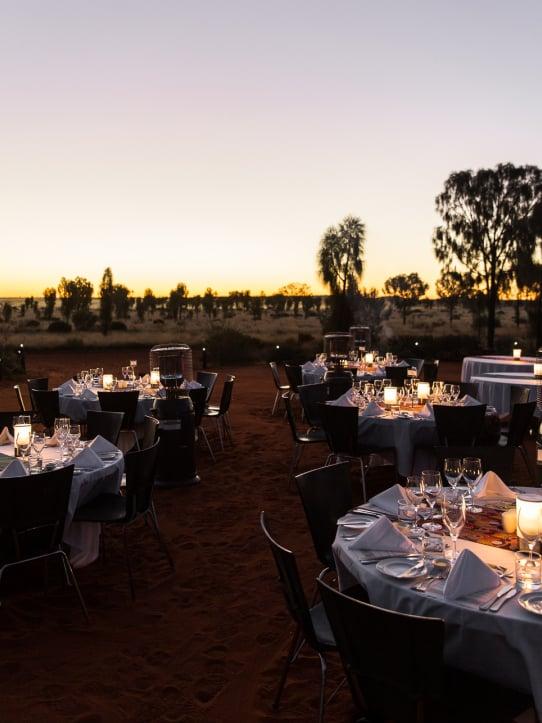 Dining tables set up outdoors at dusk