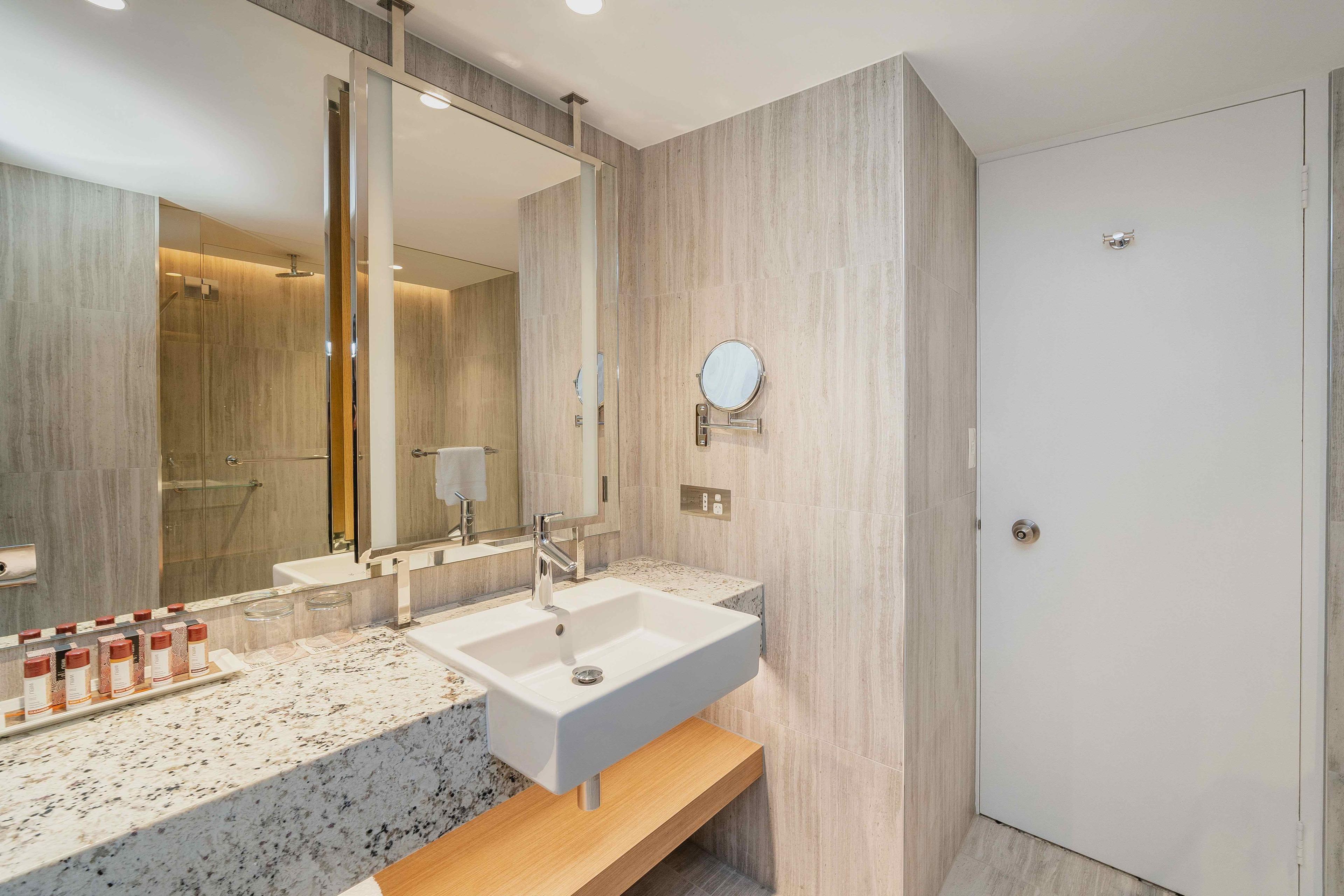 Bathroom countertop with sink and toiletries