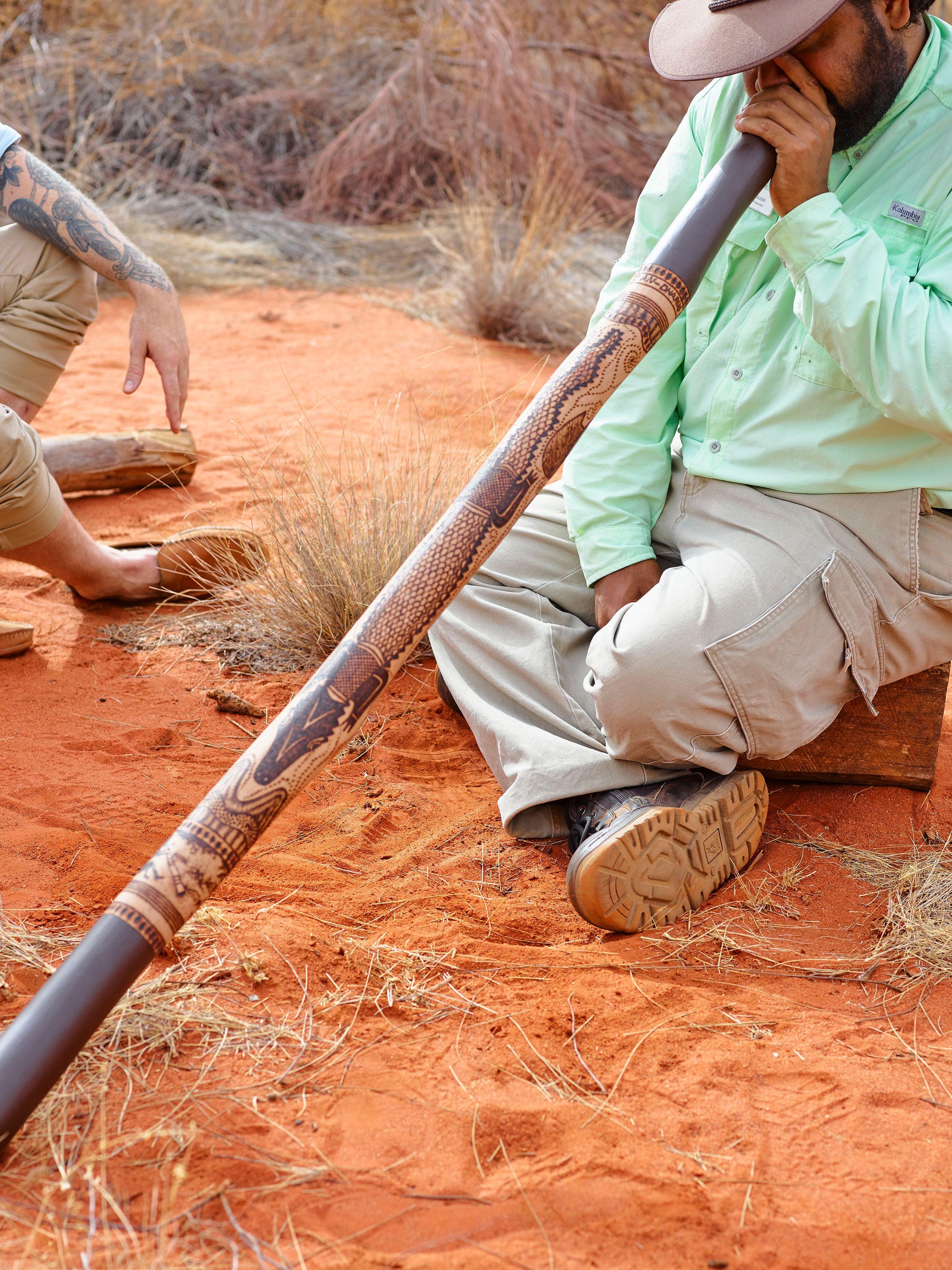 Didgeridoo being played by man in the outback