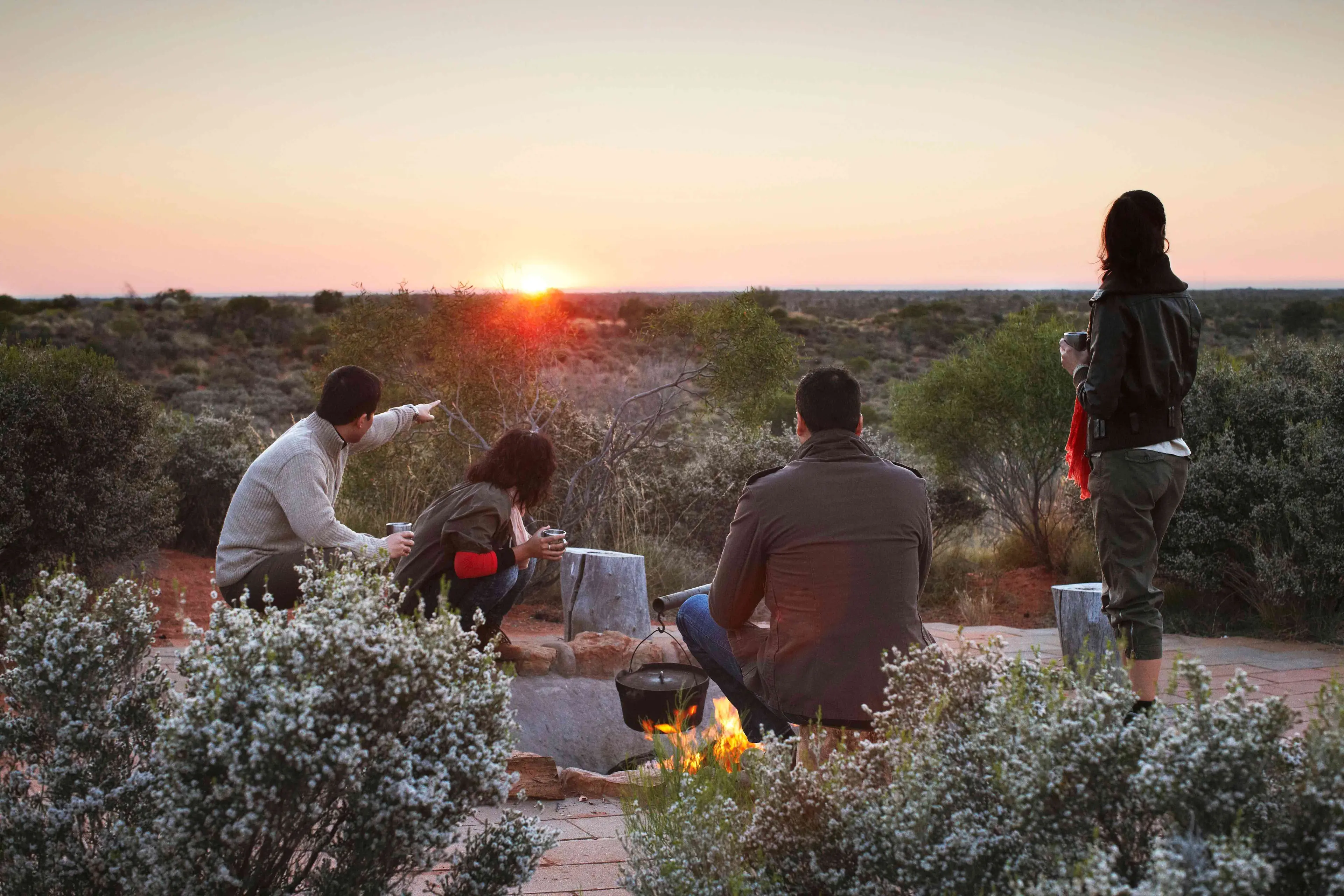 Group having coffee at sunrise at Ayers Rock outback