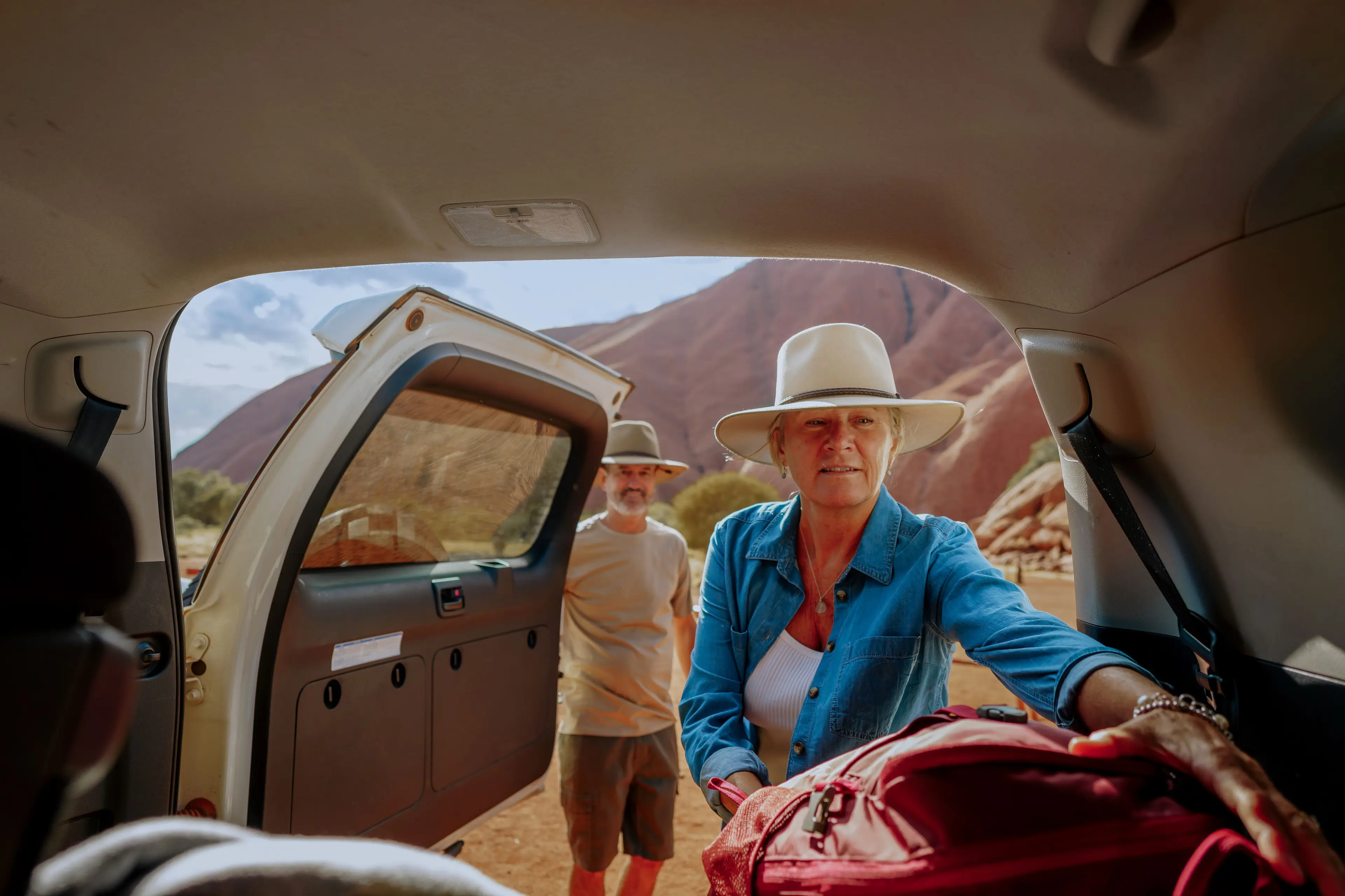 older_couple_taking_baggage_out_of_car