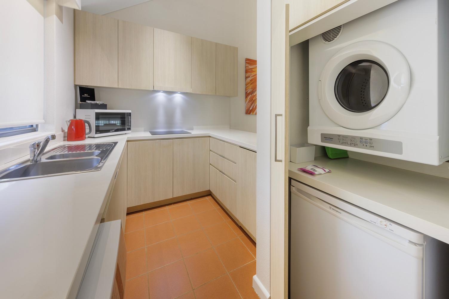Laundry within the kitchen, sink, dishwasher, cooktop and microwave