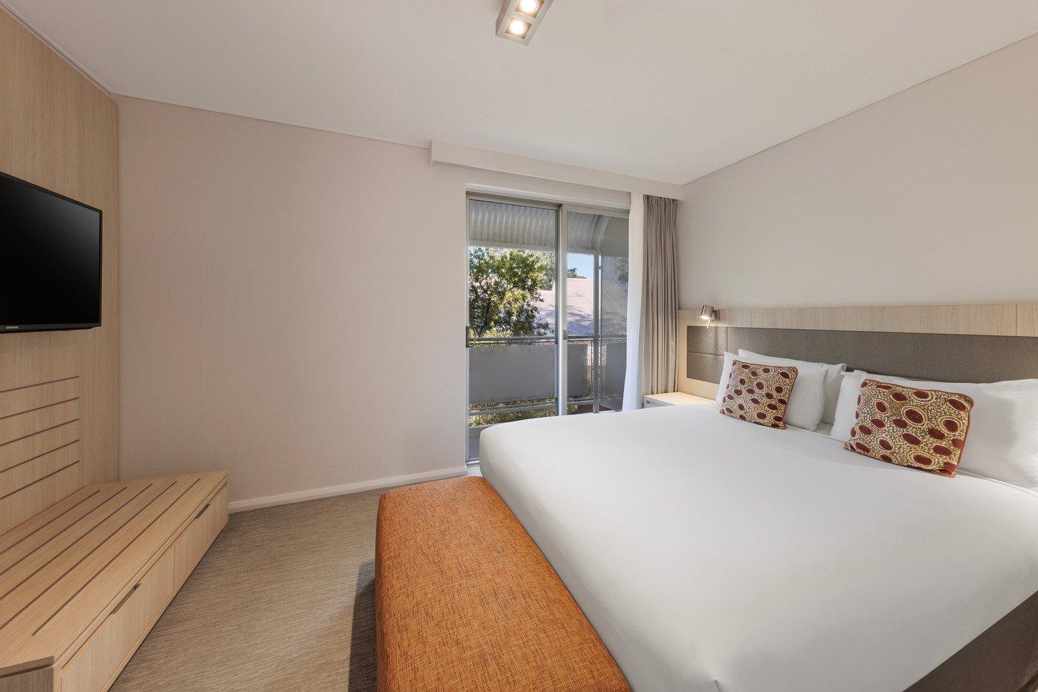 Master bedroom with tv mounted and balcony