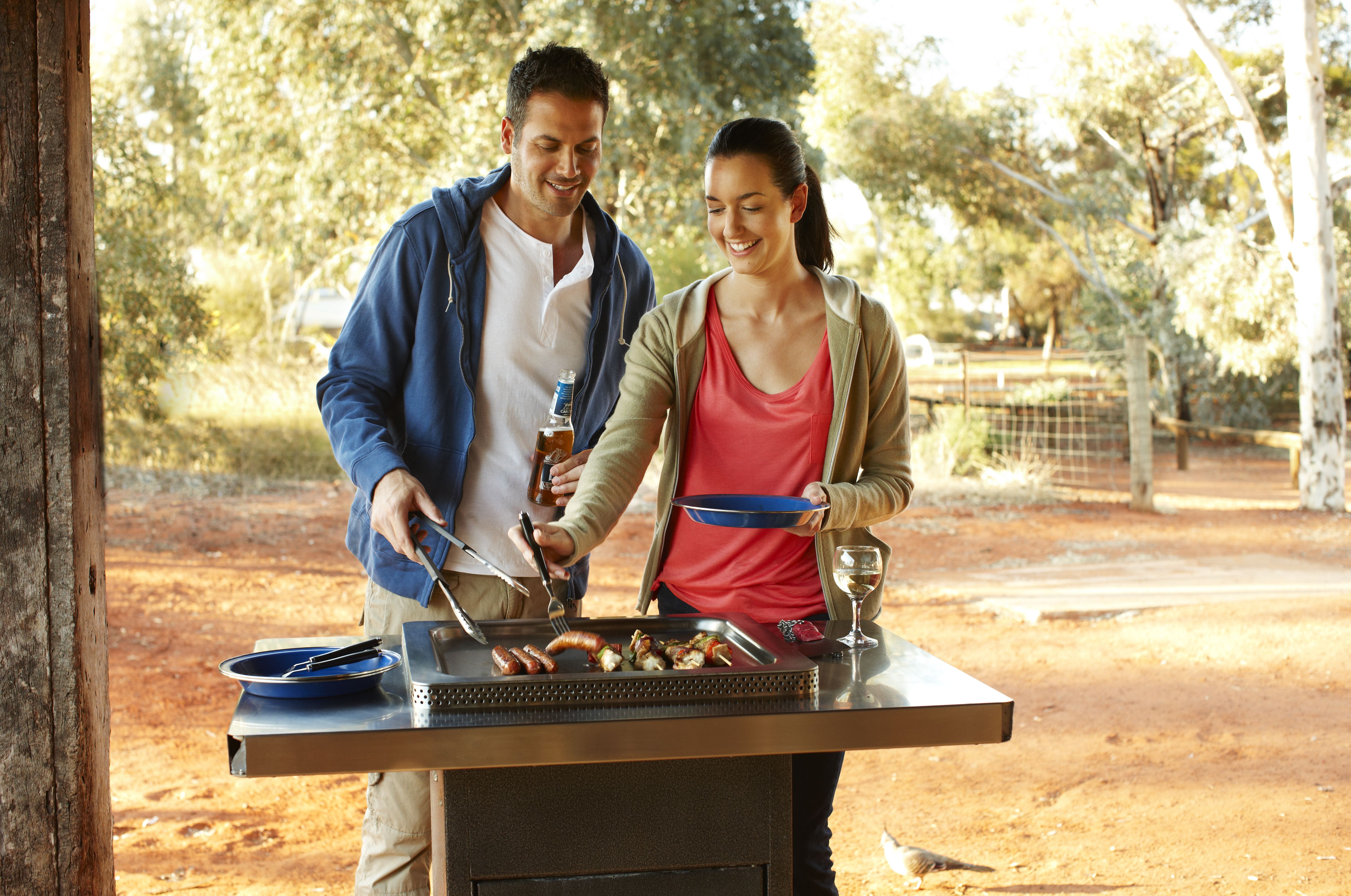 Couple cooking on a bbq in Uluru
