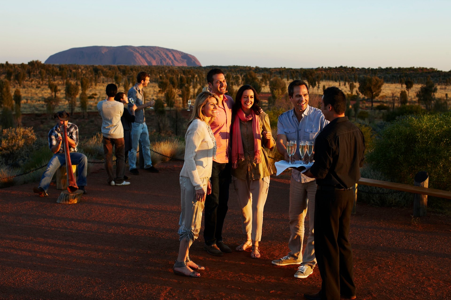 People conversing at an outdoor dinner near Ayers rock