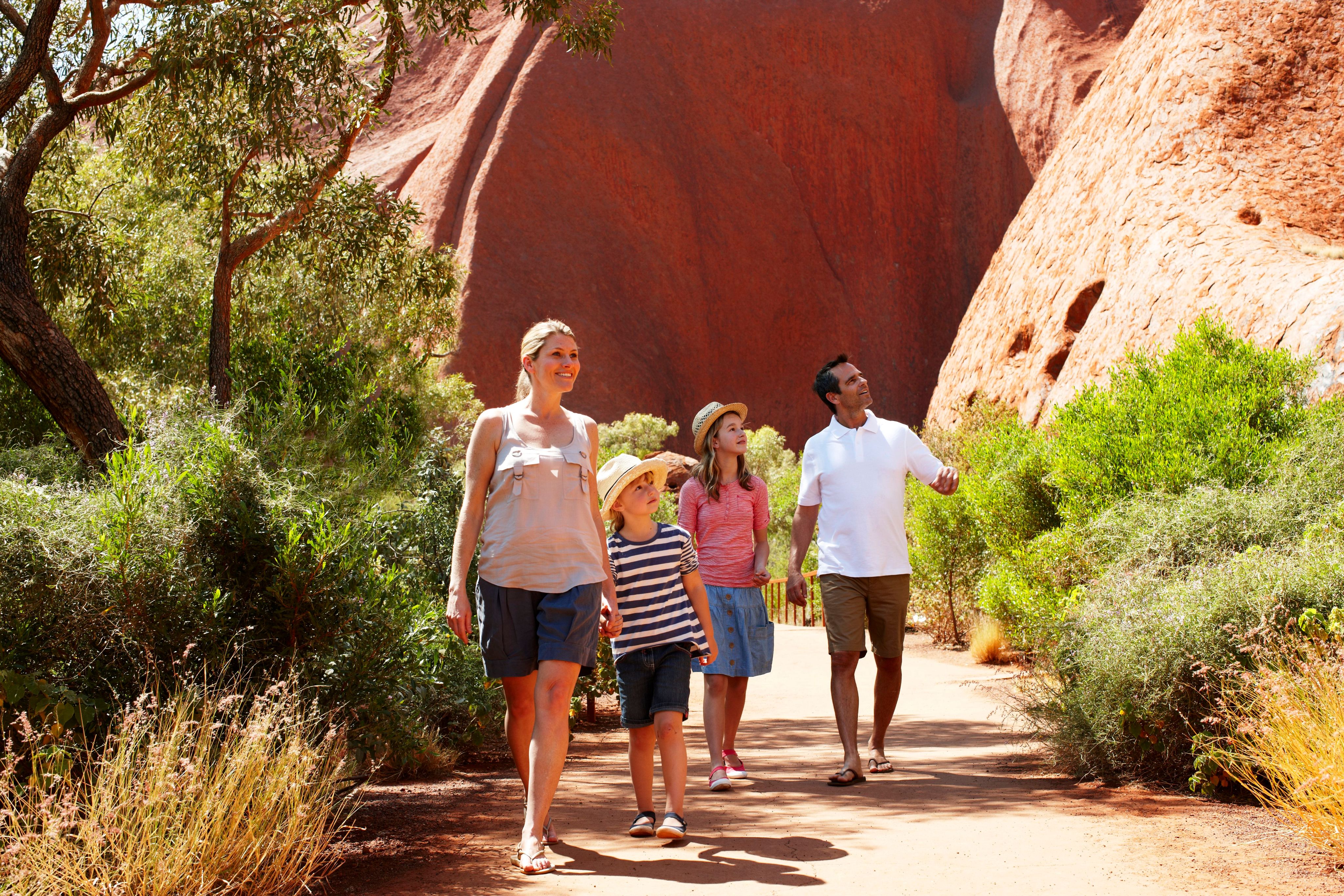 A family tours a desert landscape